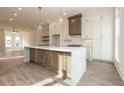 Bright kitchen featuring a large island, stylish pendant lights, and sleek countertops at 560 Fisher Dr # 48, Alpharetta, GA 30009