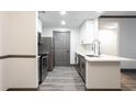 Modern kitchen boasts stainless steel appliances, white countertops, and gray cabinets at 1074 Peachtree Ne Walk # 115, Atlanta, GA 30309