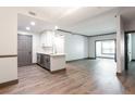 Open-concept living and kitchen area with stainless steel appliances and hardwood floors at 1074 Peachtree Ne Walk # 115, Atlanta, GA 30309