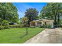 Attractive home set on a verdant lot, surrounded by mature trees and a well-kept lawn at 1424 Adele Sw Ave, Atlanta, GA 30314