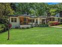 Beautifully maintained home with a vibrant green lawn and lovely landscaping at 1424 Adele Sw Ave, Atlanta, GA 30314
