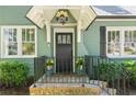 Inviting front porch with black railing, potted flowers, and a decorative door at 2759 Arbor Se Ave, Atlanta, GA 30317