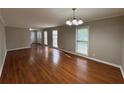 Spacious living room with hardwood flooring, neutral walls and multiple windows for natural light at 5183 Mccarter Ct, Stone Mountain, GA 30088