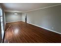 A spacious living room with freshly painted walls and gleaming hardwood floors at 5183 Mccarter Ct, Stone Mountain, GA 30088