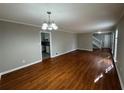 Bright living room features hardwood floors, a modern light fixture and neutral paint at 5183 Mccarter Ct, Stone Mountain, GA 30088
