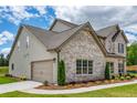 Spacious home featuring a two-car garage, brick accents, and professionally landscaped grounds at 700 Relic Rdg, Hampton, GA 30228