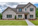 Charming brick home with well-maintained landscaping, a covered entrance, and welcoming curb appeal at 700 Relic Rdg, Hampton, GA 30228