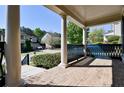 Spacious front porch featuring brick flooring, decorative railing, and grand pillars, perfect for outdoor enjoyment at 974 Regal Hills Ln, Mableton, GA 30126