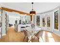 Bright, modern dining room featuring hardwood floors, stylish lighting, and access to an outdoor deck at 270 Boulder Dr, Roswell, GA 30075