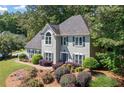 Lovely two-story home surrounded by lush trees and landscaped flowerbeds at 2009 Westside Ln, Woodstock, GA 30189
