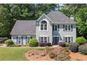 Attractive two-story home featuring a gray facade, black shutters, and mature landscaping at 2009 Westside Ln, Woodstock, GA 30189