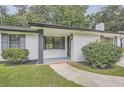 Inviting covered front porch with painted brick, lush bushes, and a manicured lawn at 2714 Preston Dr, Decatur, GA 30034