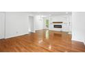 Spacious living room featuring hardwood floors, electric fireplace and an open floor plan at 5935 Christopher Ln, Lithonia, GA 30058
