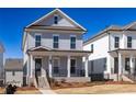 Charming two-story home with a welcoming front porch and professionally landscaped yard at 171 Basil Street Dr, Cumming, GA 30040
