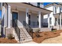 Inviting front porch with brick stairs and iron railings, perfect for relaxing outdoors at 171 Basil Street Dr, Cumming, GA 30040