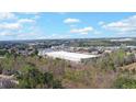 View of a large warehouse and surrounding landscape under a sunny, partly cloudy sky at 2195 Brickton Sta, Buford, GA 30518