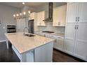 Modern kitchen with large island, stainless steel appliances, and white cabinets at 6603 Sterling Dr, Atlanta, GA 30328