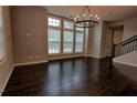 Inviting living room featuring hardwood floors, lots of windows and modern chandelier at 6603 Sterling Dr, Atlanta, GA 30328