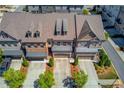 Aerial view of upscale townhomes featuring well-maintained roofs and landscaping in a desirable community at 1005 Milhaven Dr, Roswell, GA 30076