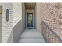 Inviting entryway featuring brick facade, elegant door, and stylish address number for a touch of curb appeal at 1005 Milhaven Dr, Roswell, GA 30076