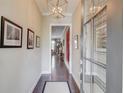 Bright and airy hallway with hardwood floors, elegant lighting, and tasteful decor, creating a welcoming entrance at 1005 Milhaven Dr, Roswell, GA 30076