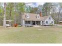 Quaint two-story home features a welcoming front porch, complemented by a swing and lush greenery at 1484 W Prospect Dr, Lawrenceville, GA 30043