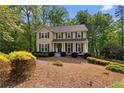 Inviting two-story home with a well-manicured lawn, mature trees, and a classic design, perfect for Gathering living at 480 Springs End Ne Ln, Marietta, GA 30068