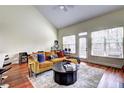 A modern living room with vaulted ceilings, lots of windows, and hardwood floors at 5883 Brookside Oak Cir, Norcross, GA 30093