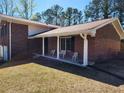 The brick home has a covered front porch with decorative white chairs and pillars at 2117 Chestnut Hill Cir, Decatur, GA 30032