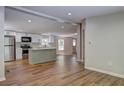 Open concept kitchen featuring stainless steel appliances, white cabinets, and a functional center island at 350 White Birch Dr, Covington, GA 30016