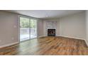 Living room featuring a cozy fireplace with marble accents and sliding glass door leading to outdoor deck at 350 White Birch Dr, Covington, GA 30016