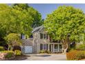 Beautiful brick home with a two-car garage, large trees and manicured landscaping at 4350 Oakdale Vinings Se Cir, Smyrna, GA 30080
