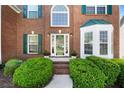 Inviting front entrance with brick steps and lush green bushes at 1517 Granby Ln, Locust Grove, GA 30248