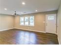 Bright living room with hardwood floors, a ceiling fan, and a large window at 3207 Canary Ct, Decatur, GA 30032