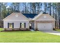 Charming single-story home with gray siding, brick accents, a dormer window, and a well-manicured lawn at 486 Charleston Pl, Villa Rica, GA 30180