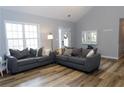 Bright living room with vaulted ceilings, wood floors, and comfortable seating at 1043 Foxhollow Trl, Canton, GA 30115