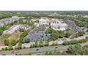 Aerial shot showcases hospital buildings, expansive parking lots, and surrounding trees and landscape at 1610 Glenhurst Dr, Snellville, GA 30078