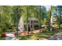 Inviting home with a screened in porch, two car garage, lush lawn, and mature trees at 2441 Mitchell Ne Rd, Marietta, GA 30062