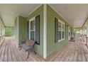 Inviting, expansive front porch perfect for relaxing with seating at 503 Pinehurst Ln, Woodstock, GA 30188
