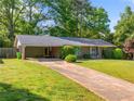 Lovely one-story brick house showcasing a long driveway and a well-maintained lawn at 1153 Chatsworth Dr, Avondale Estates, GA 30002