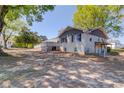 Spacious backyard featuring a white brick house with a deck, offering a charming outdoor living space at 1312 Harbins Rd, Dacula, GA 30019