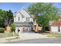 Charming two-story home with a two-car garage and well-manicured lawn and mature landscaping at 2525 Ashton Dr, Roswell, GA 30076