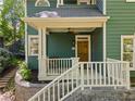 Charming front porch with wooden door, white railings, and a cozy seating area at 446 Harold Ne Ave, Atlanta, GA 30307