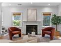 Elegant living room with fireplace, comfortable seating, and natural light from two windows at 446 Harold Ne Ave, Atlanta, GA 30307