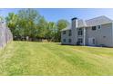 Spacious backyard with a lush green lawn, trees and privacy fence at 100 Wyngate Chase, Stockbridge, GA 30281