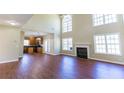 Open concept living area with a soaring ceiling, fireplace and view into kitchen at 100 Wyngate Chase, Stockbridge, GA 30281