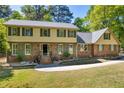 Beautiful two-story home featuring classic brick facade, green shutters, and manicured landscaping at 1851 Mount Vernon Rd, Dunwoody, GA 30338