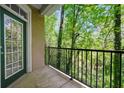 Balcony overlooking lush green trees and a black metal railing at 4201 Stratford Commons, Decatur, GA 30033