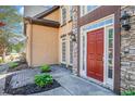 Stylish entryway with a red front door, stone accents, and manicured landscaping at 4609 Mctyre Way, Marietta, GA 30064