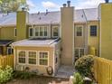 Exterior view of the back of the house with a cozy patio area and well-maintained yard at 595 Saint James Se Walk, Marietta, GA 30067